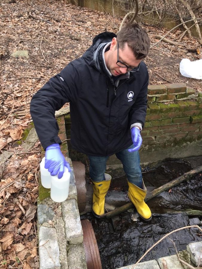 Matthew McEnerney collecting stormwater samples in the field